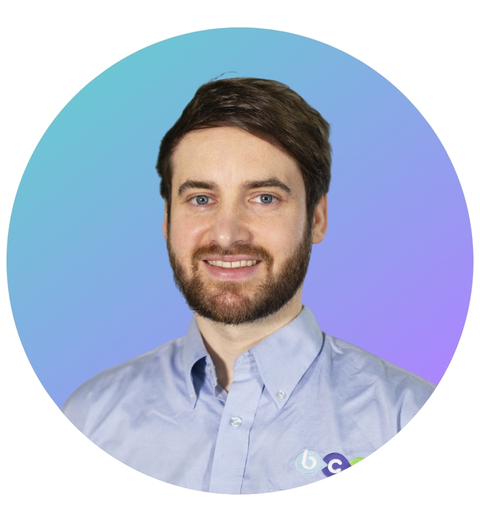 Portrait of BCS Managing Director Martin Hynes on a blue and purple gradient background.