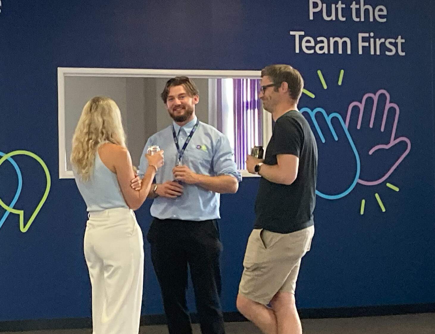 Account Manager Aaron Rosser talking with clients in the office.