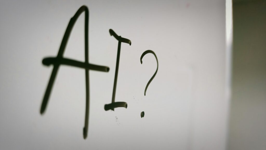 Whiteboard with "AI?" written on it.