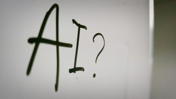 Whiteboard with "AI?" written on it.
