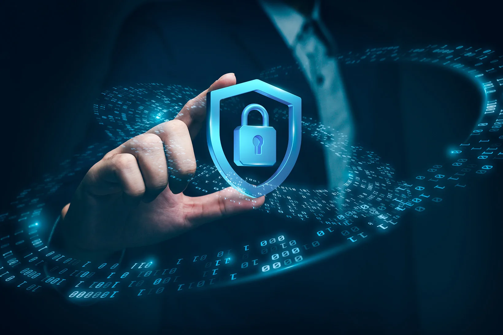 Hand holding a shield icon with a padlock in it to represent cybersecurity.